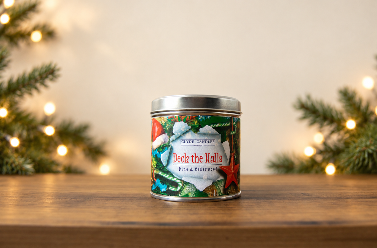 Clyde Candles Deck the Halls Pine & Cedarwood candle in a festive illustrated tin with a silver lid