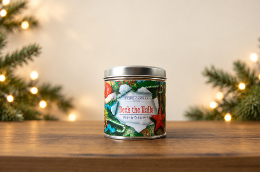 Clyde Candles Deck the Halls Pine & Cedarwood candle in a festive illustrated tin with a silver lid
