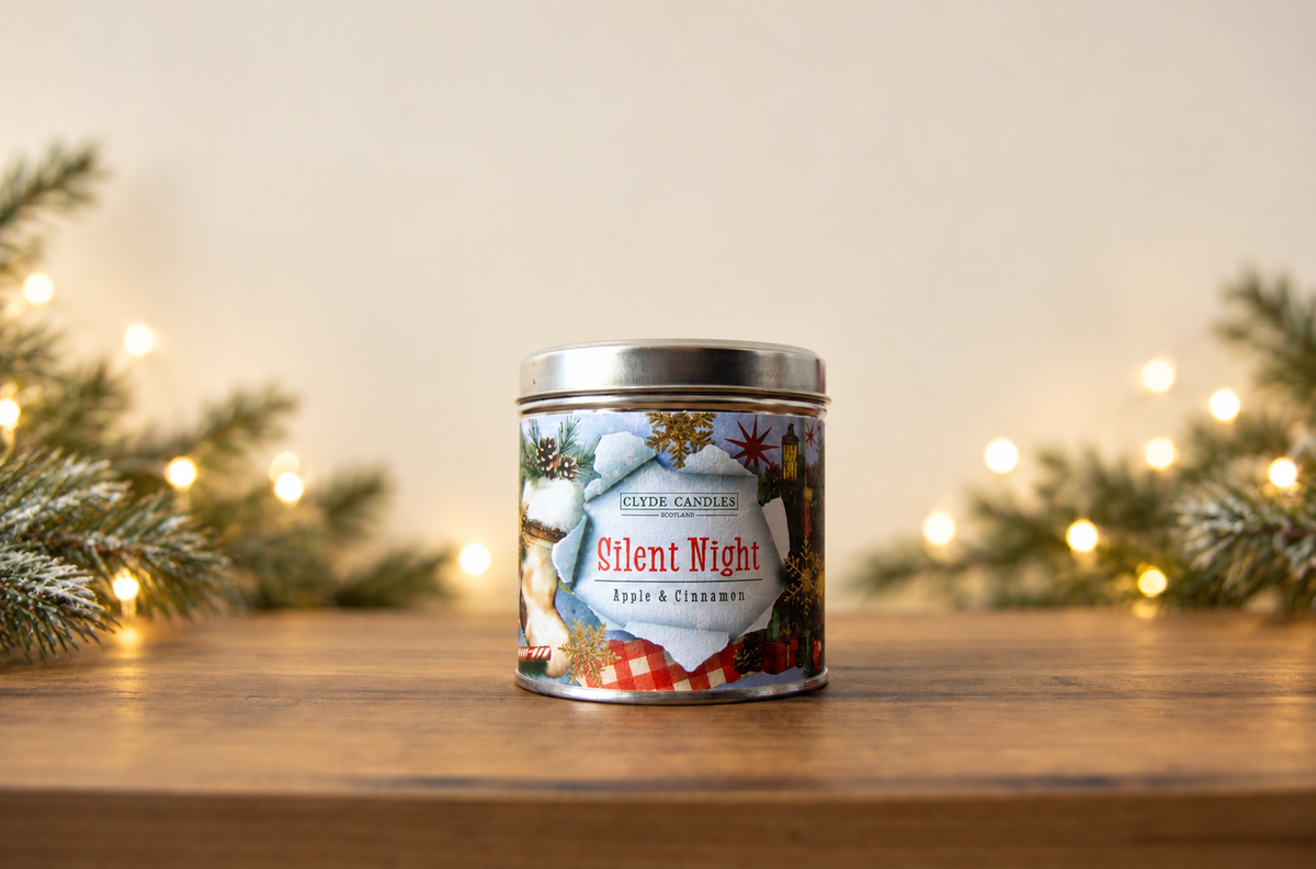 Clyde Candles Silent Night Apple & Cinnamon candle in a festive illustrated tin with a silver lid