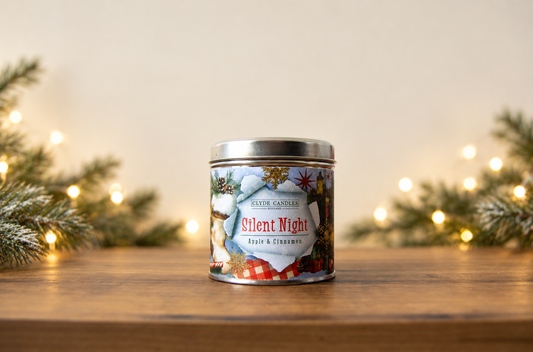 Clyde Candles Silent Night Apple & Cinnamon candle in a festive illustrated tin with a silver lid